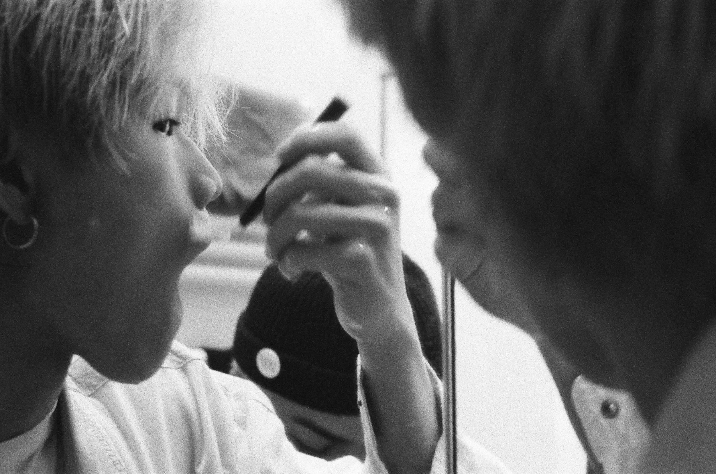 Black-and-white image of makeup being applied.