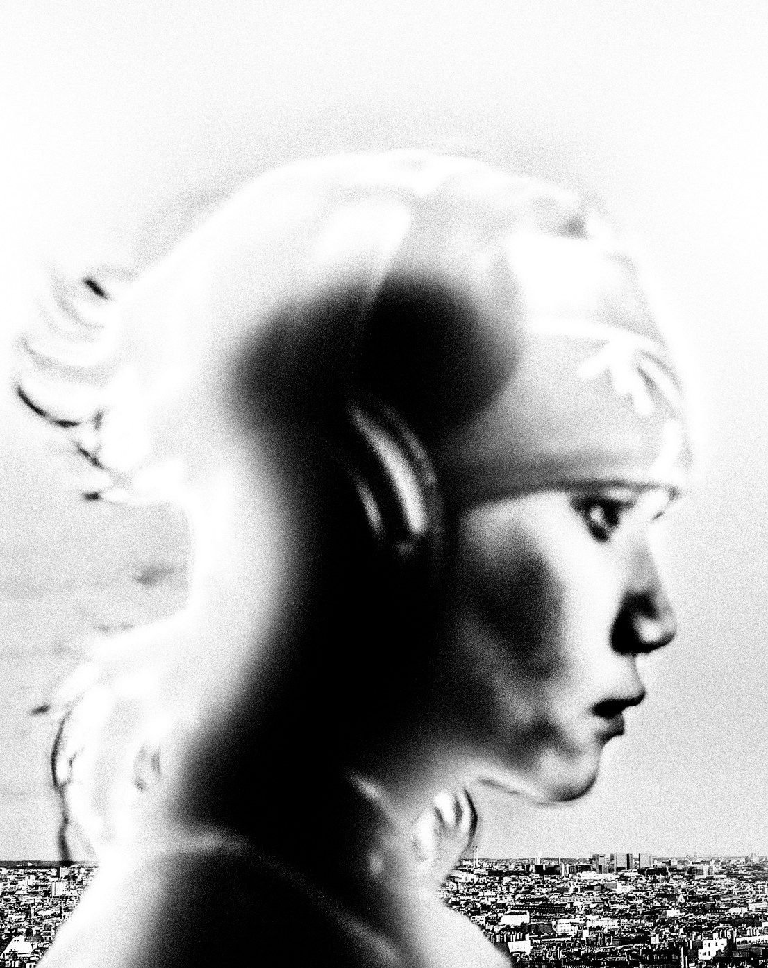 Black-and-white profile layered with a city view.