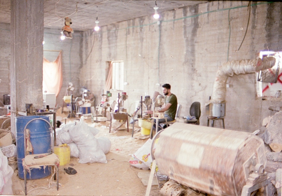 People working in a light-filled workshop.