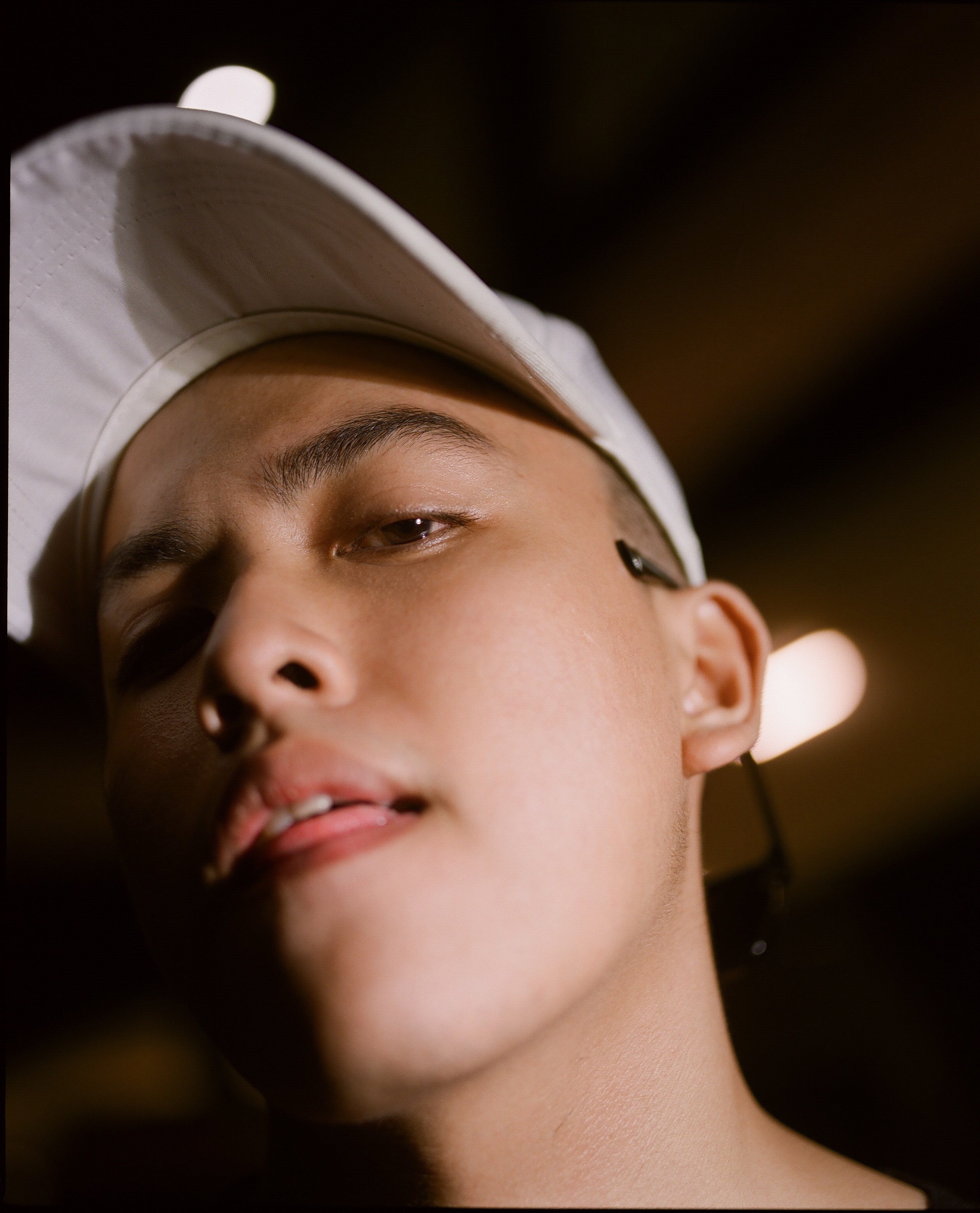 Close portrait in a white cap.