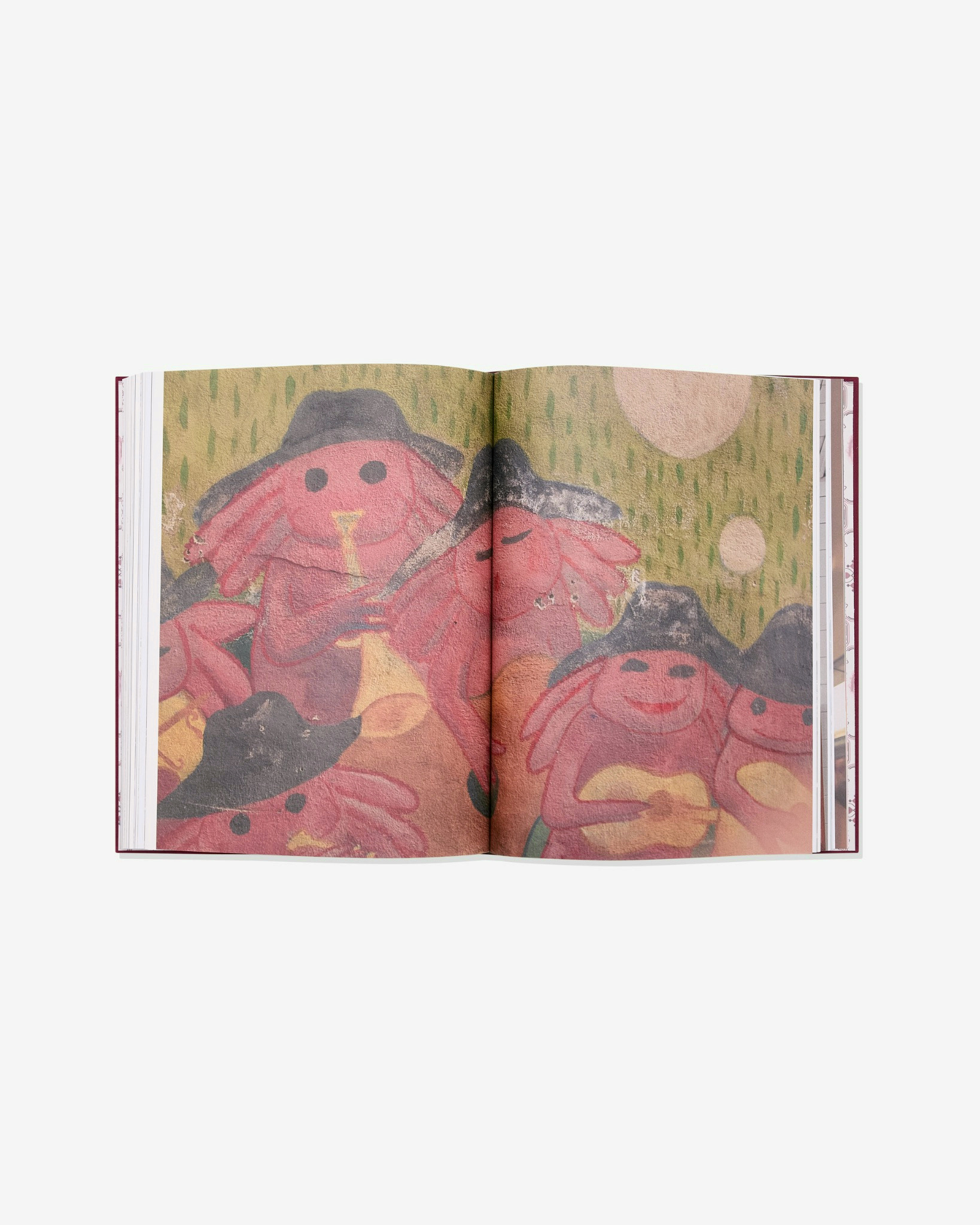 Open book showing a vernacular painted image spread.