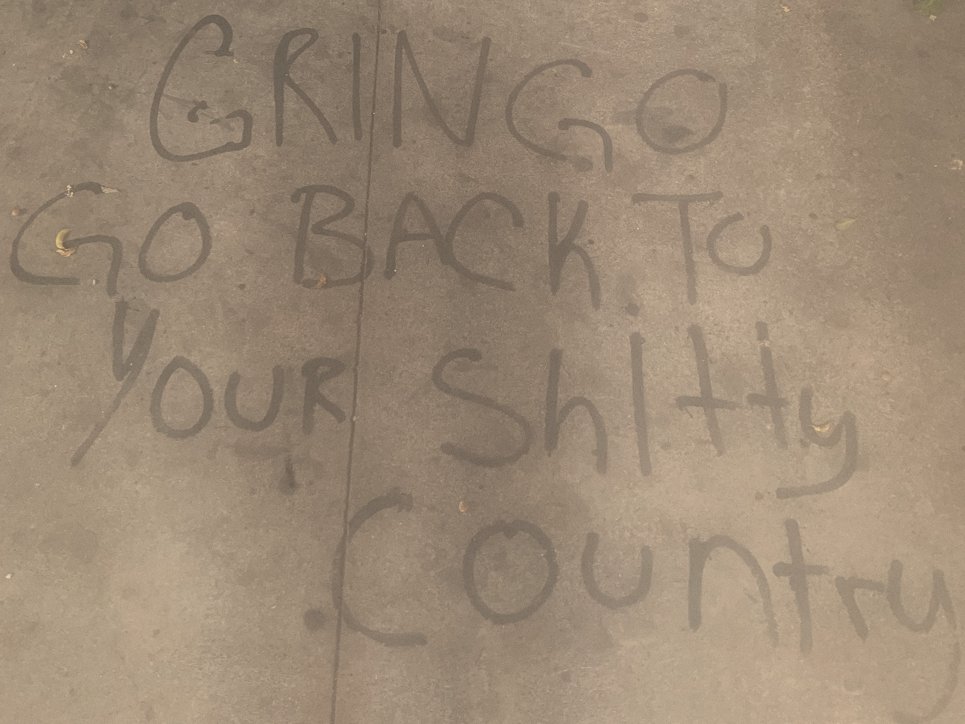 Handwritten wall text reading ‘GRINGO GO BACK TO YOUR SHITTY COUNTRY’, Mexico City, 2024.