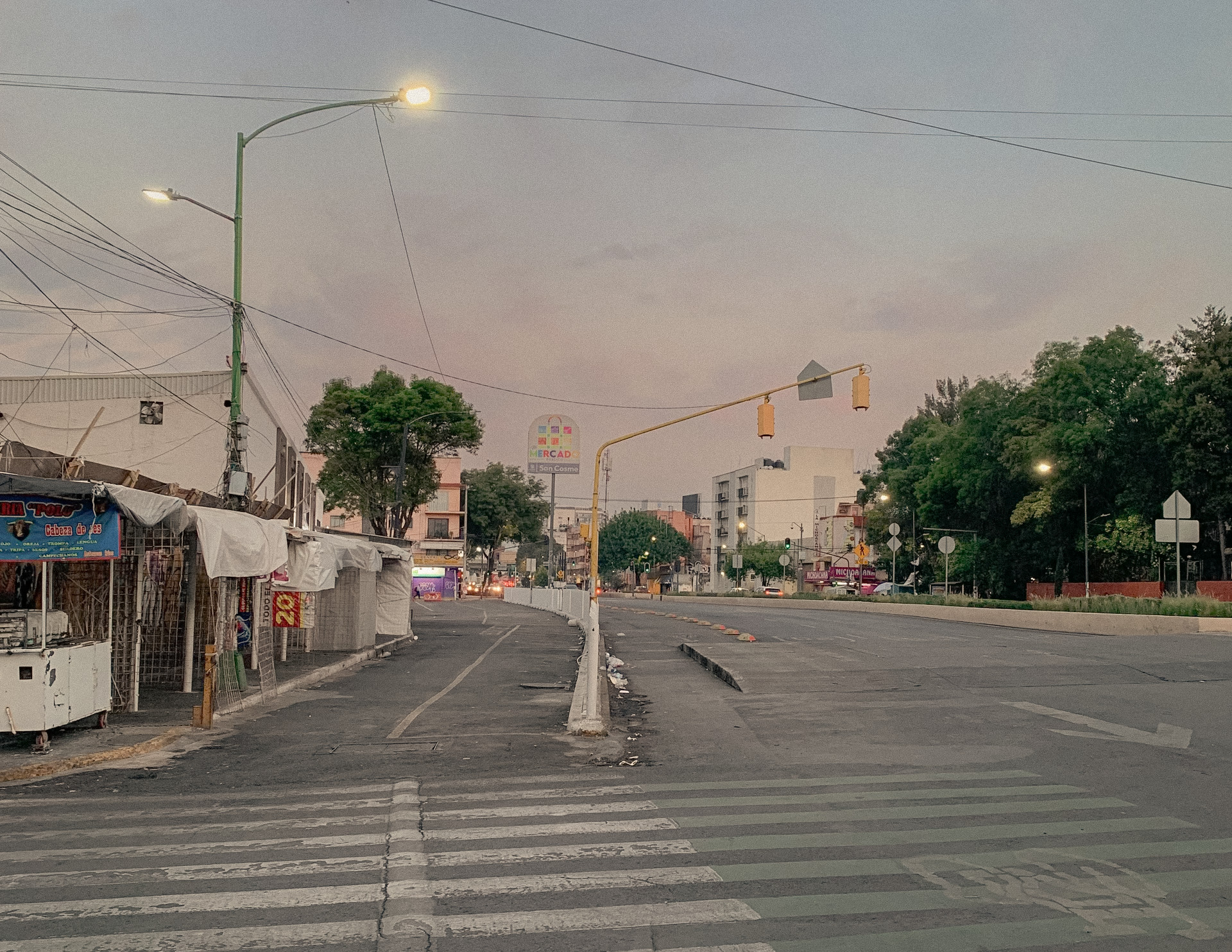 An empty road and suspended traffic lights at dusk, Mexico City, 2024.