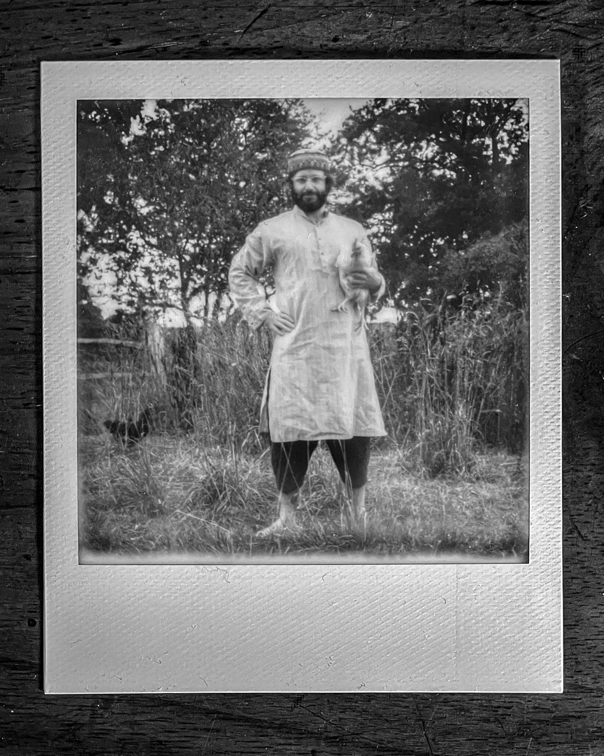A black-and-white instant photograph of Ryan O’Toole Collett outdoors.