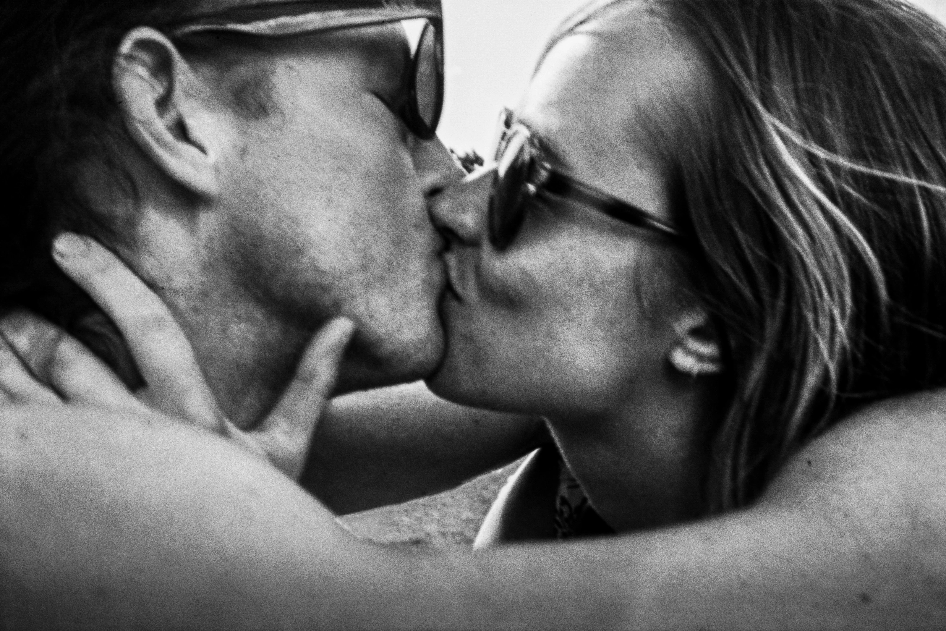 Black-and-white photograph: two people kissing.