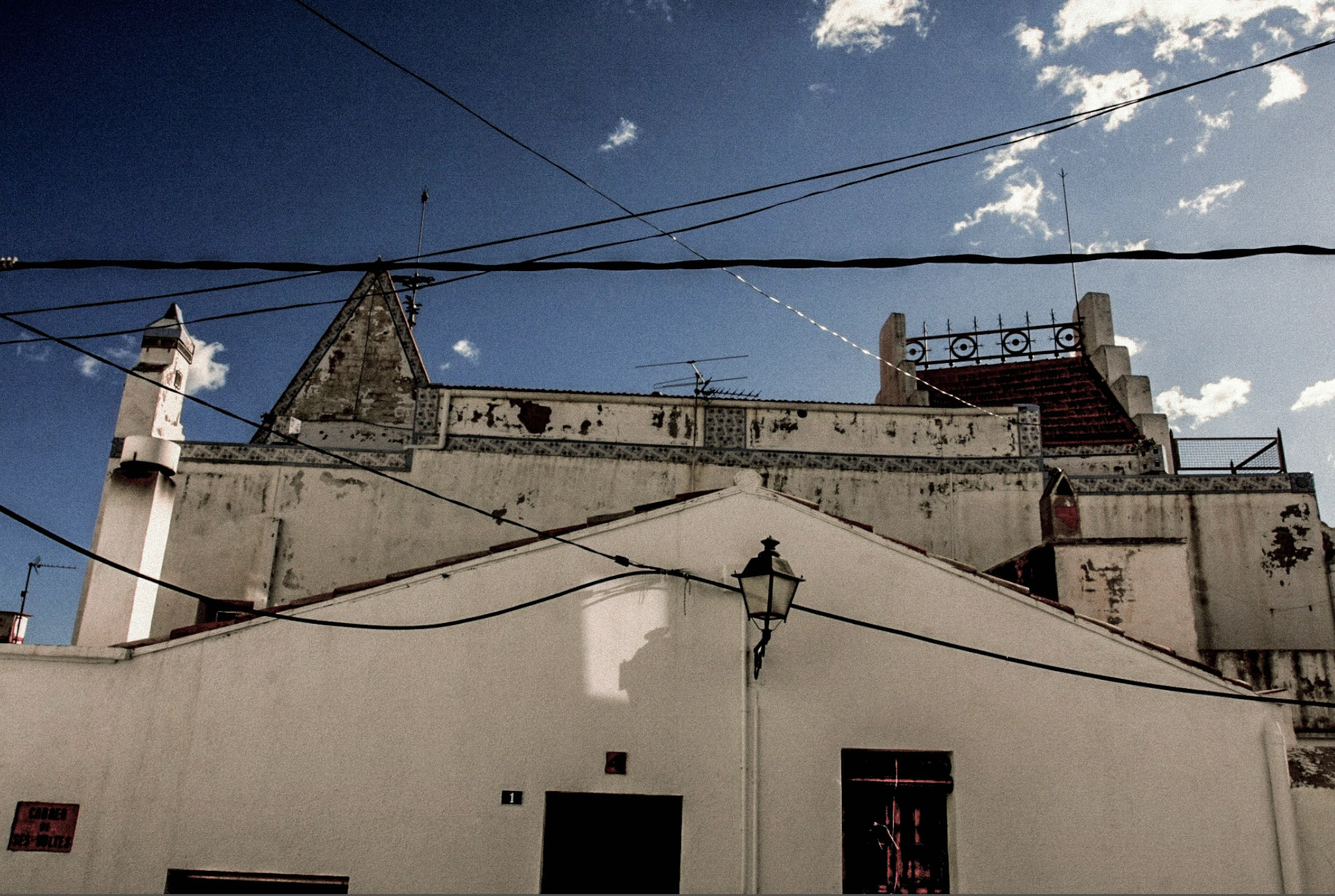 Church roof and overhead wires.