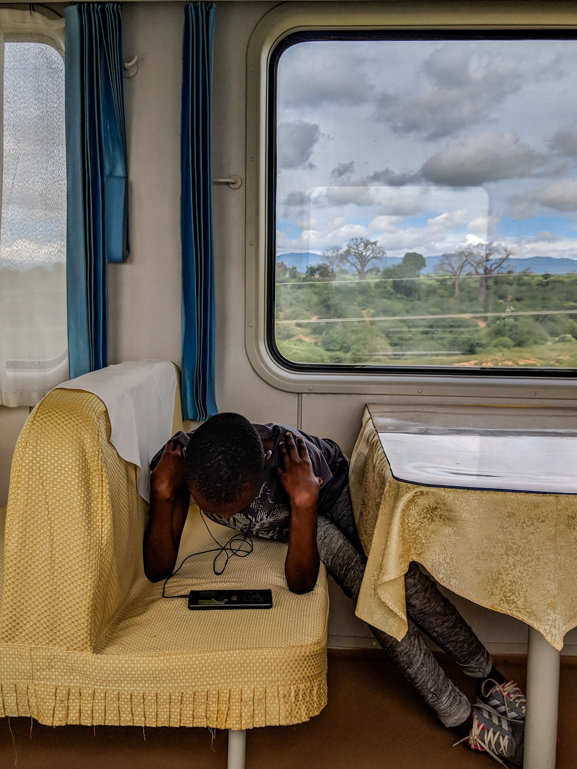 Passenger bending between train seats.