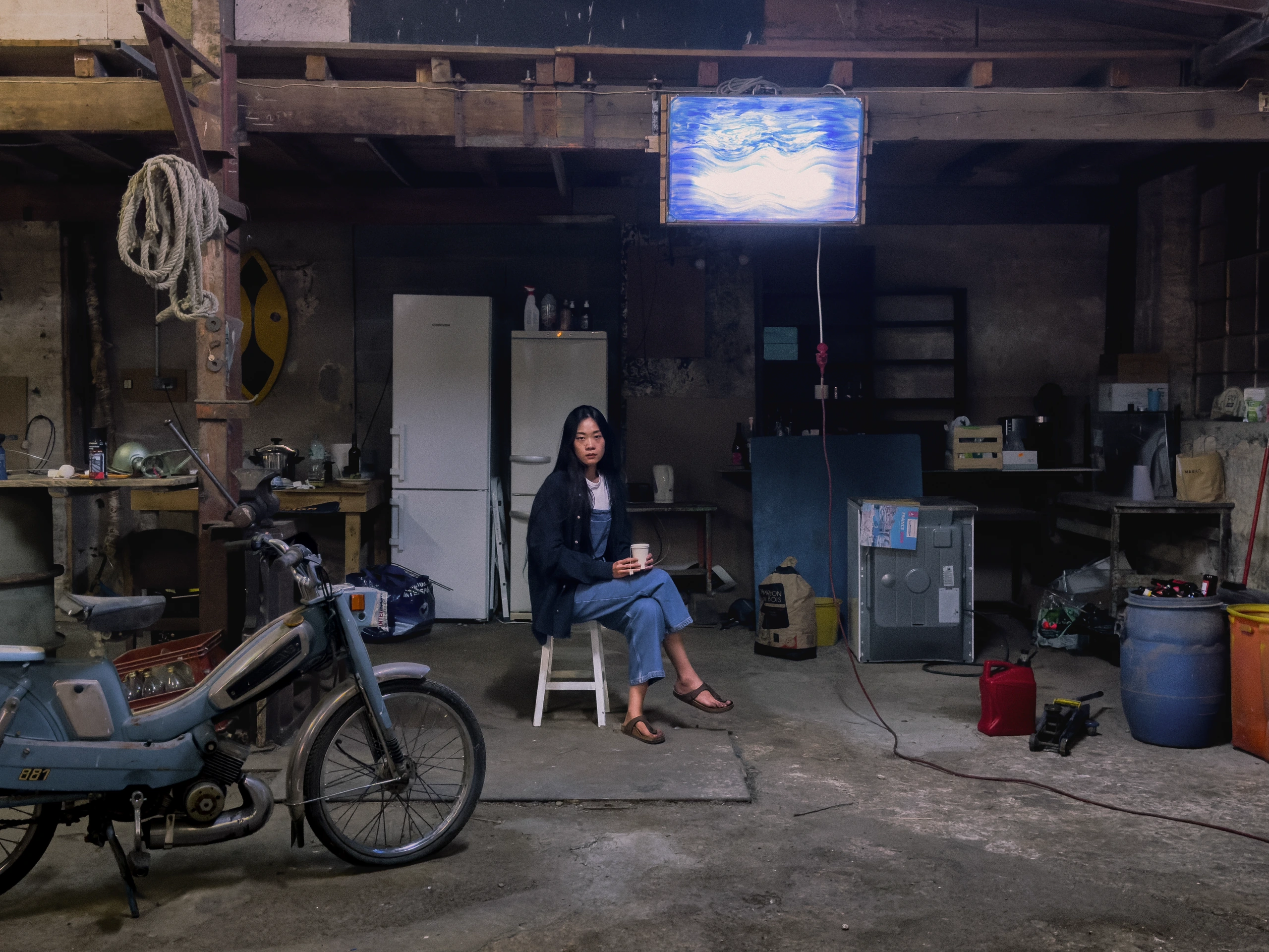 Seated woman in workshop.