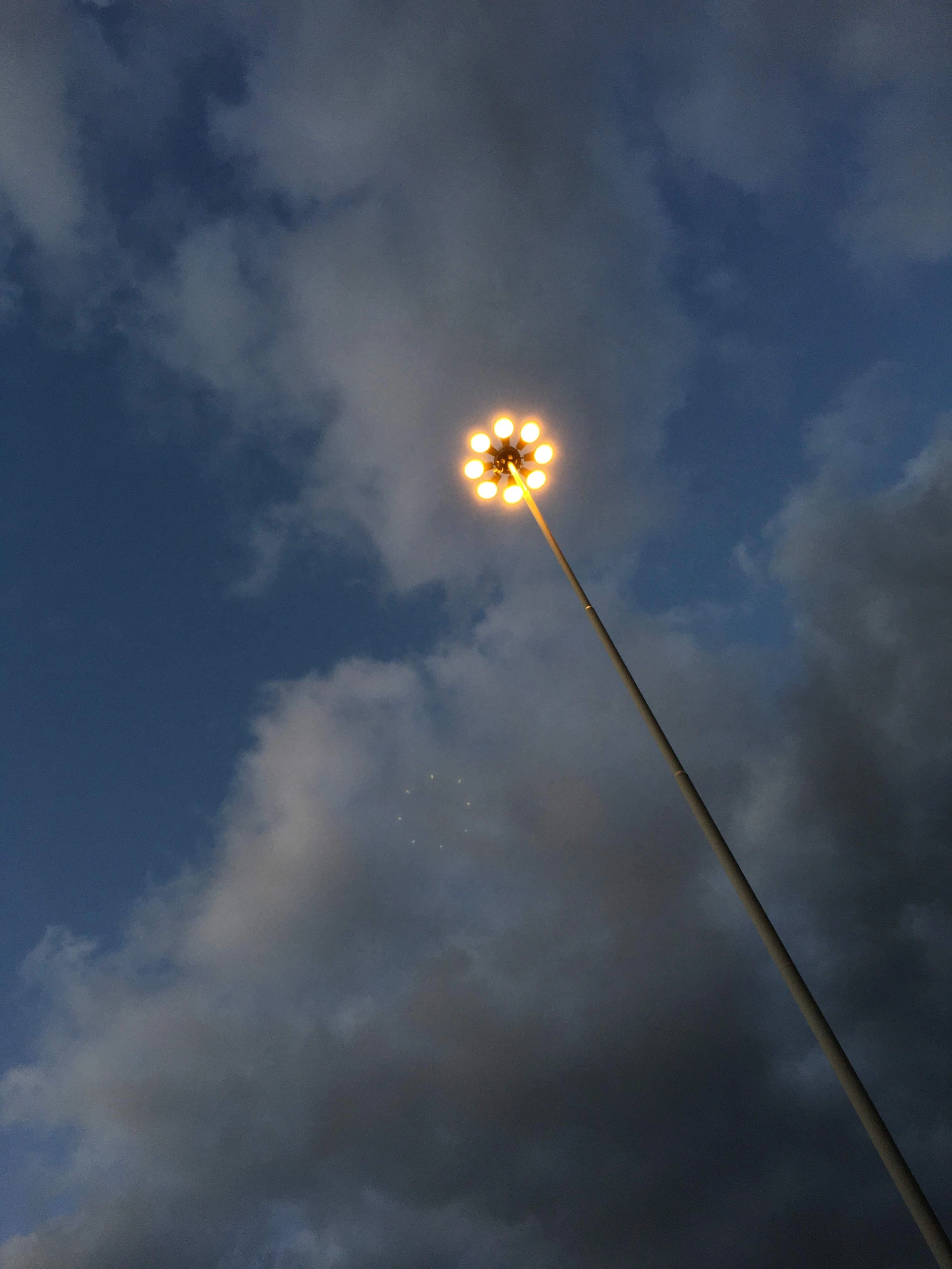 Streetlight against cloudy sky.