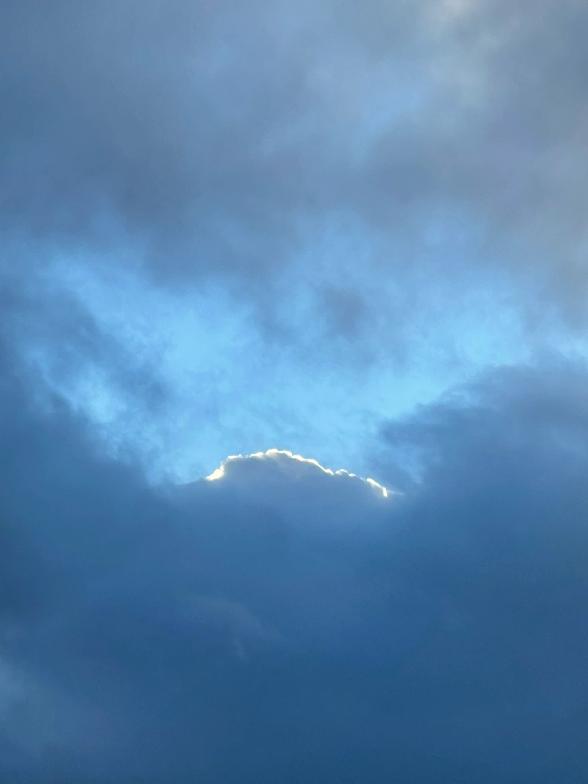 Bright cloud edge against blue sky.