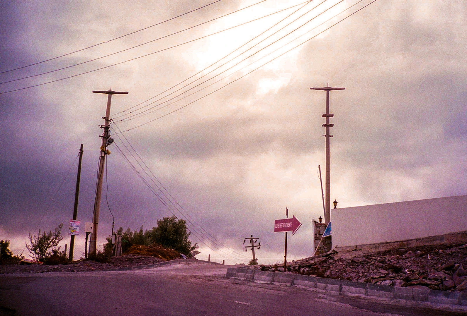 Road rising between utility poles.