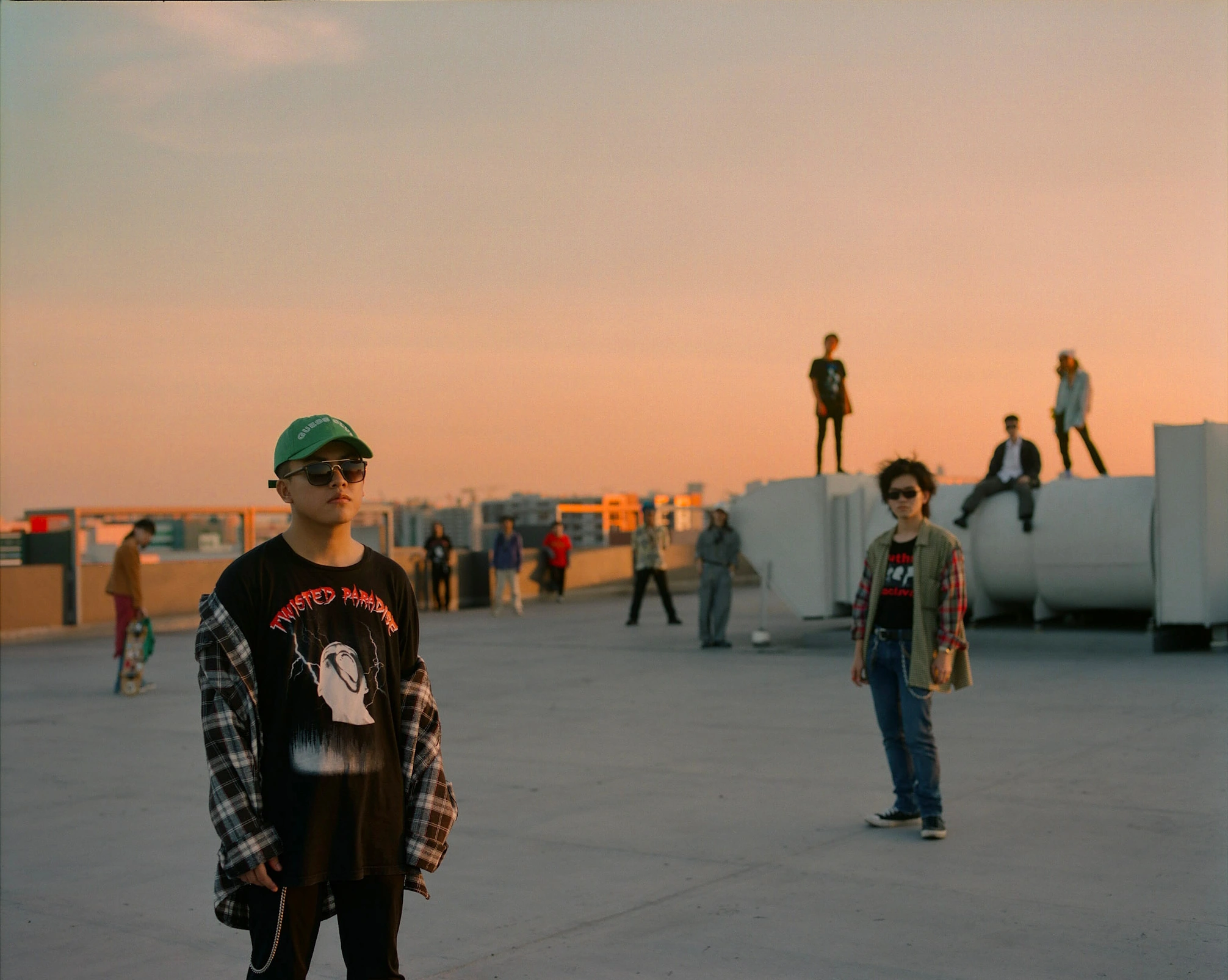 Youths on rooftop at sunset.