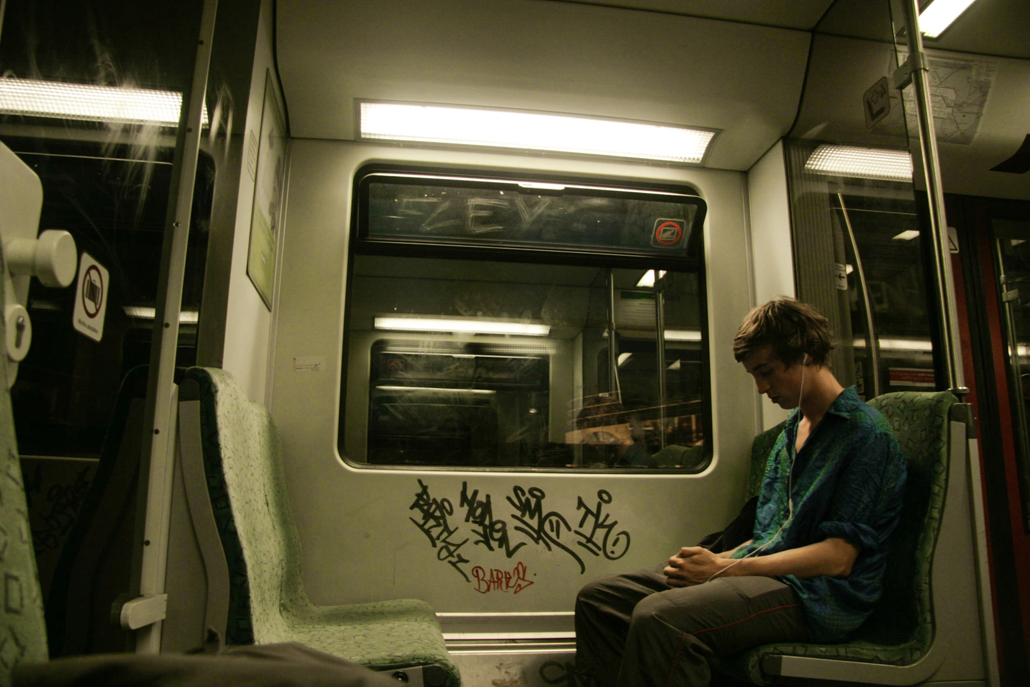 Passenger in graffiti-marked carriage.