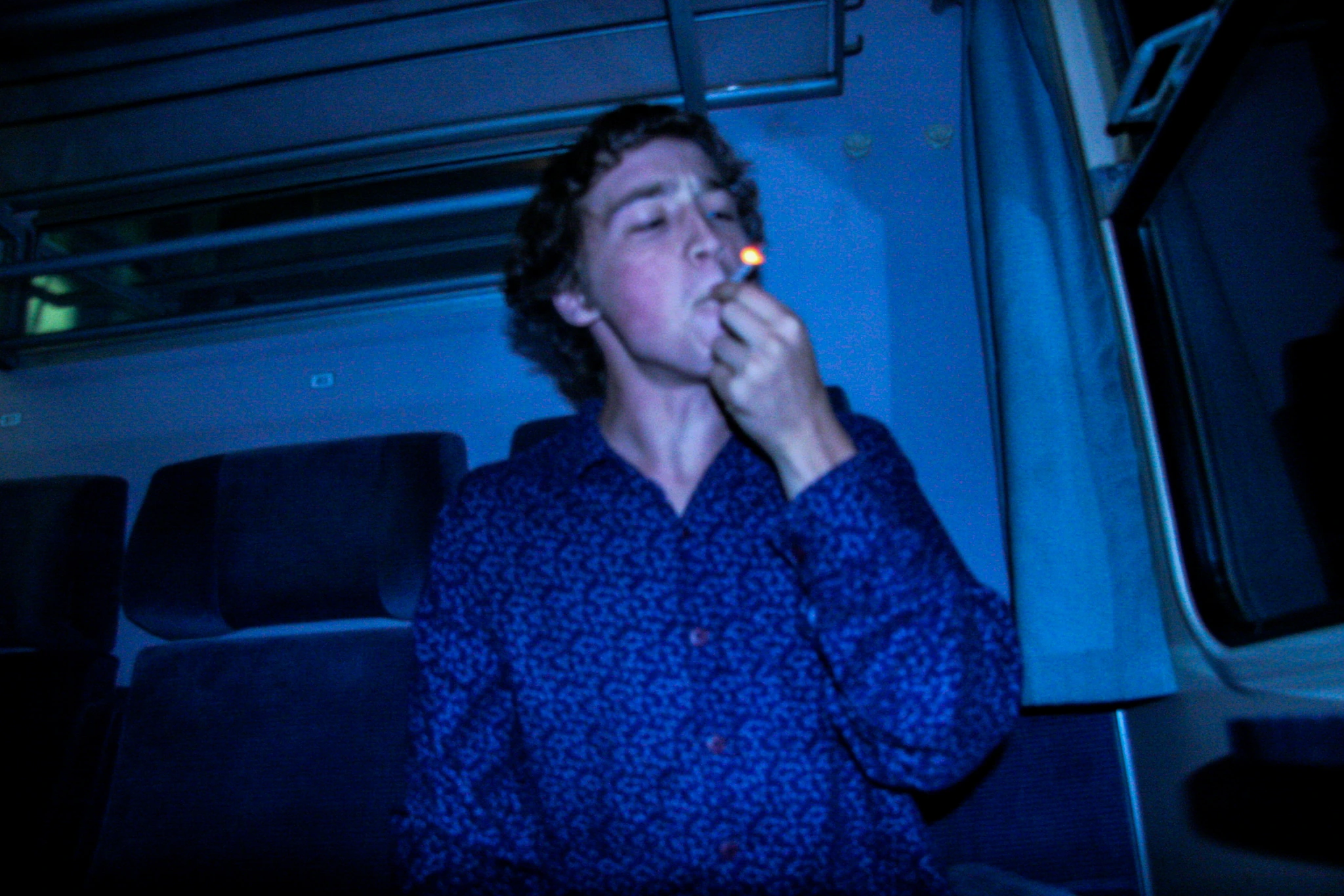 Smoking passenger in blue light.