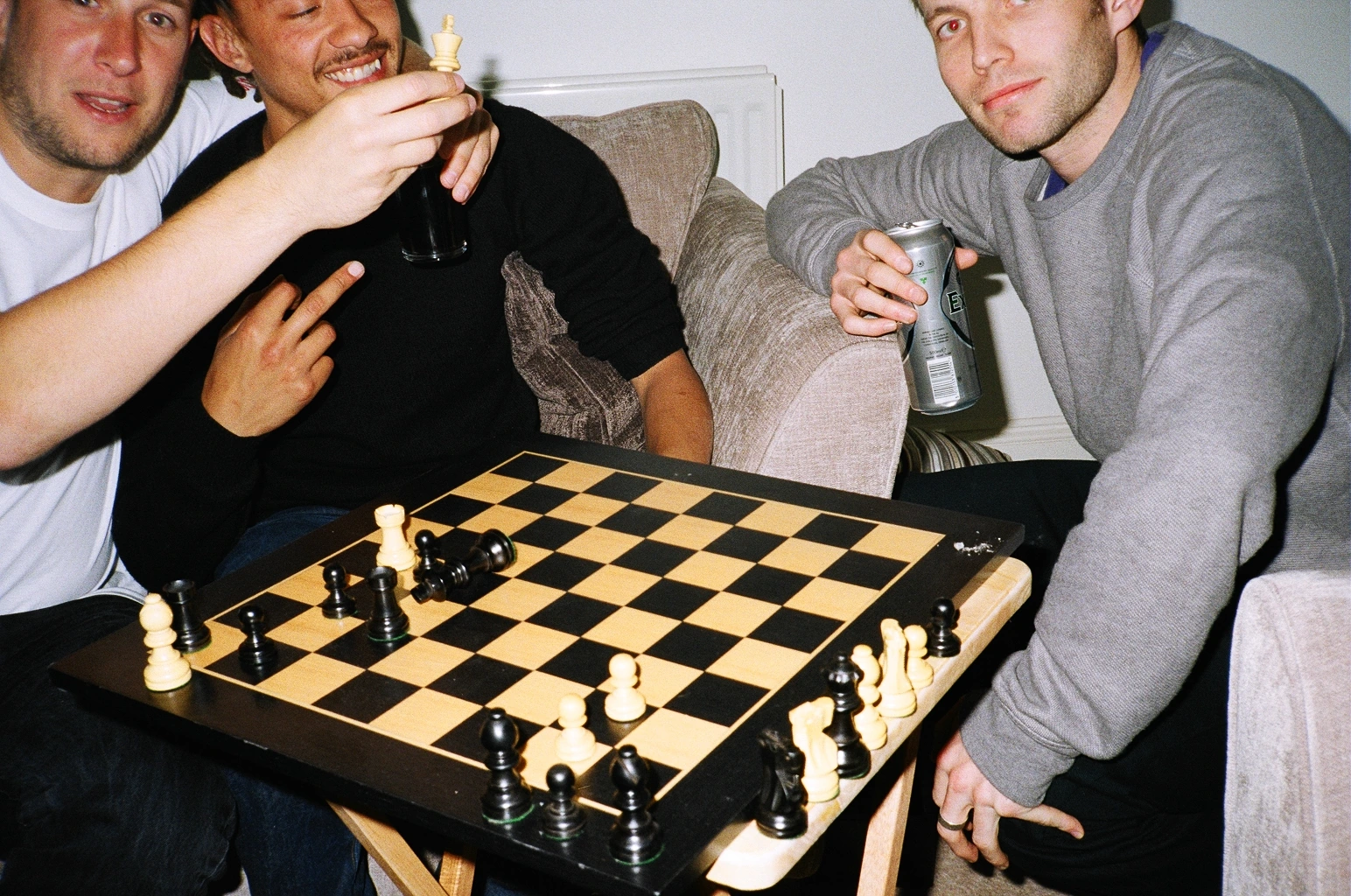 Friends around chessboard.