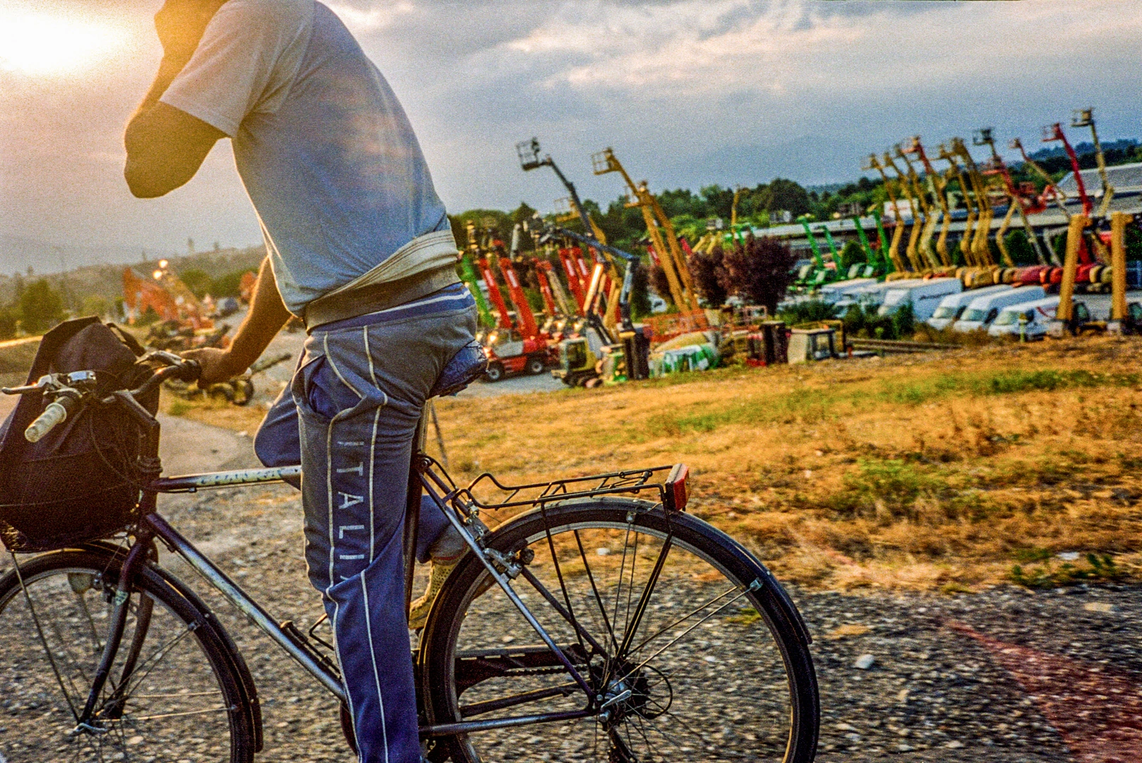 Cyclist beside outdoor fairground.