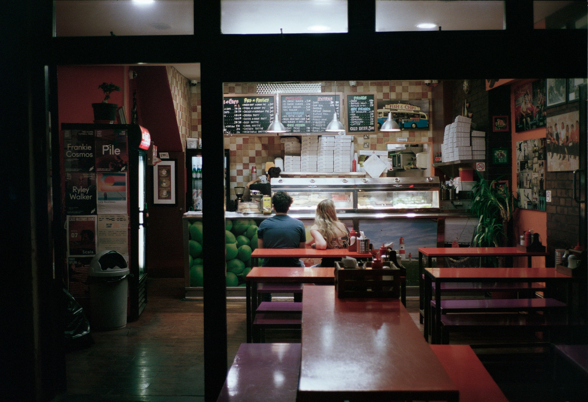 Diners seen through restaurant doorway.