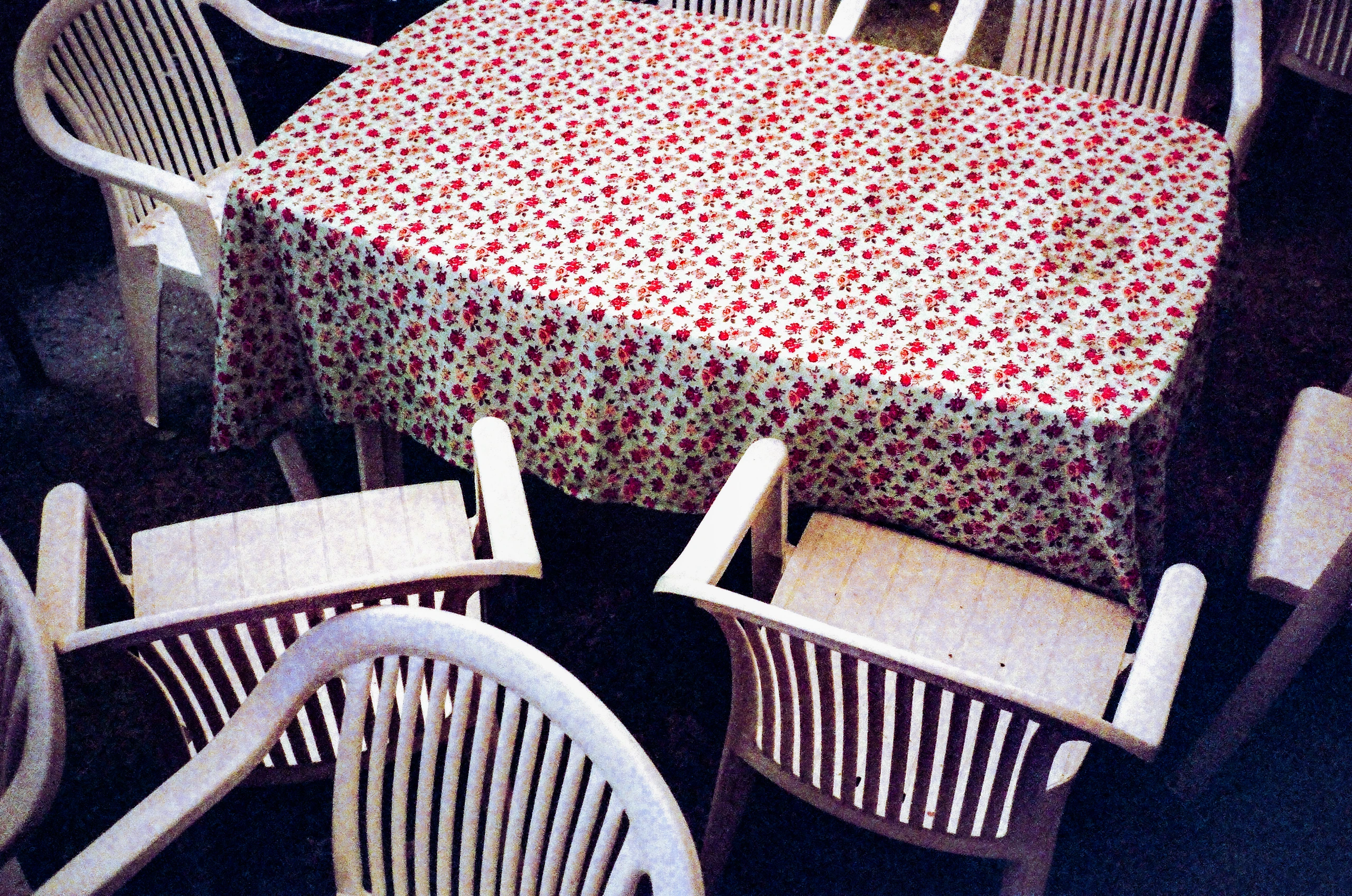 Floral tablecloth and chairs.