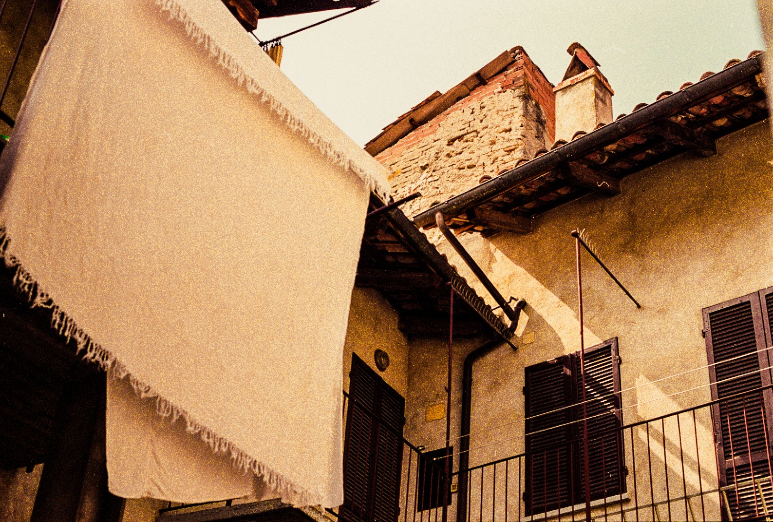 Warm-toned courtyard and balcony.