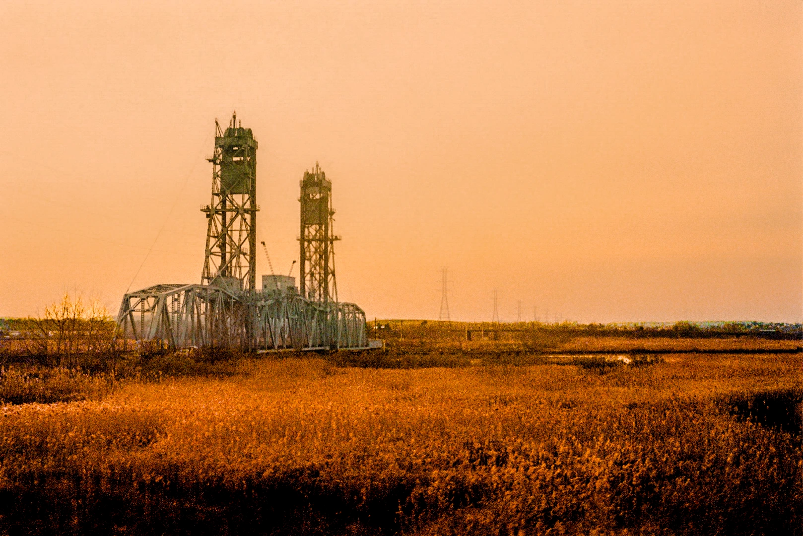 Industrial towers in orange landscape.