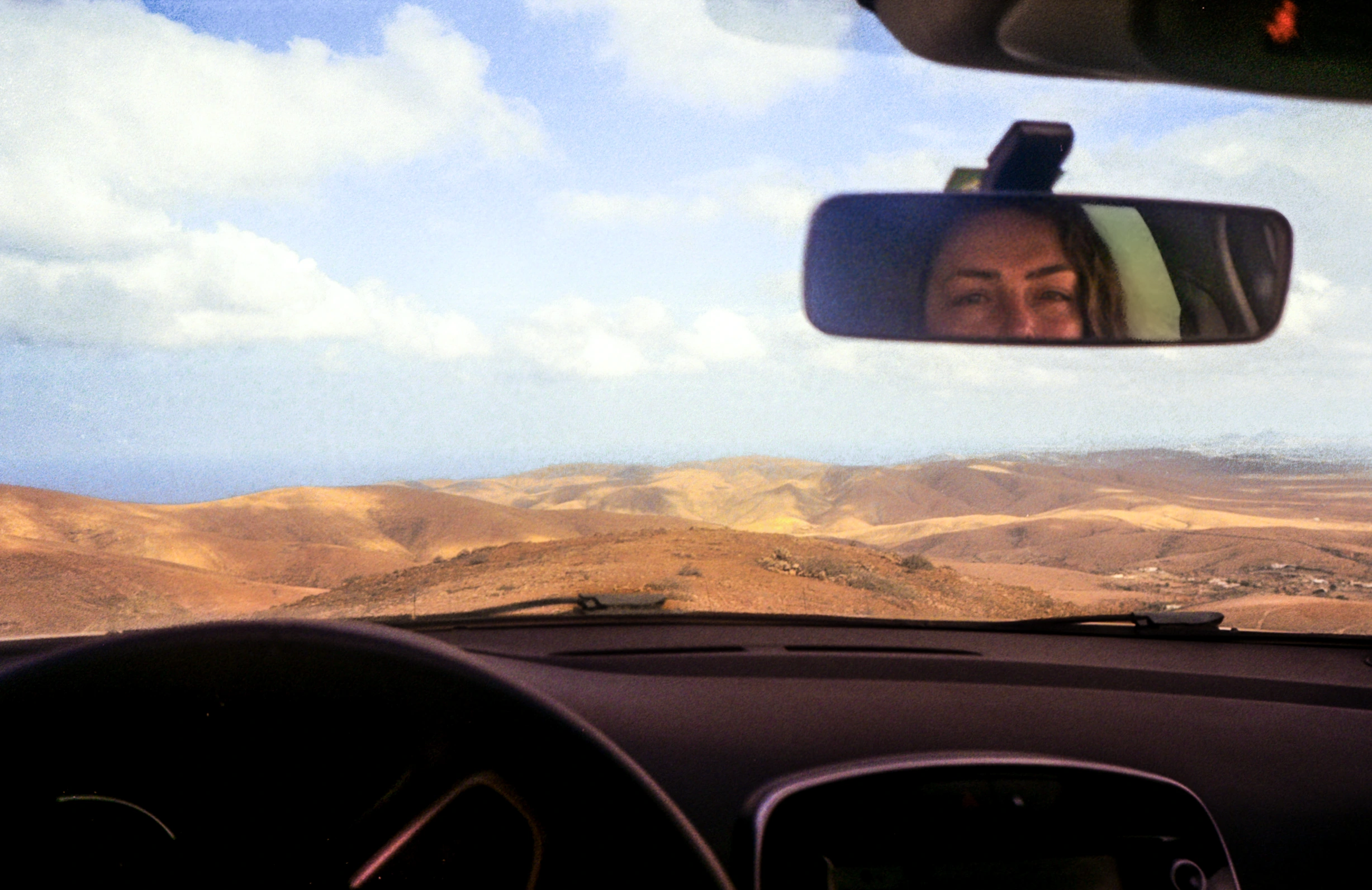 Desert through car windscreen.