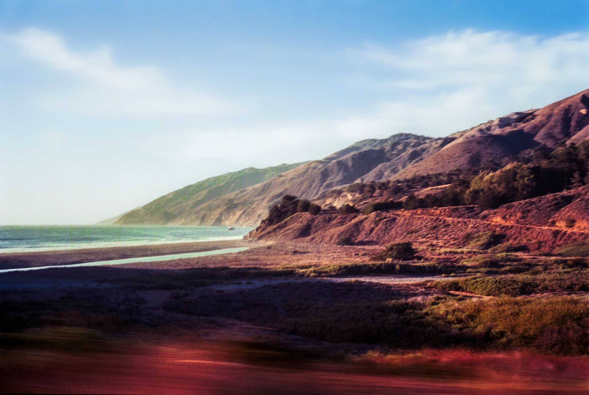 Mountains beside shoreline.