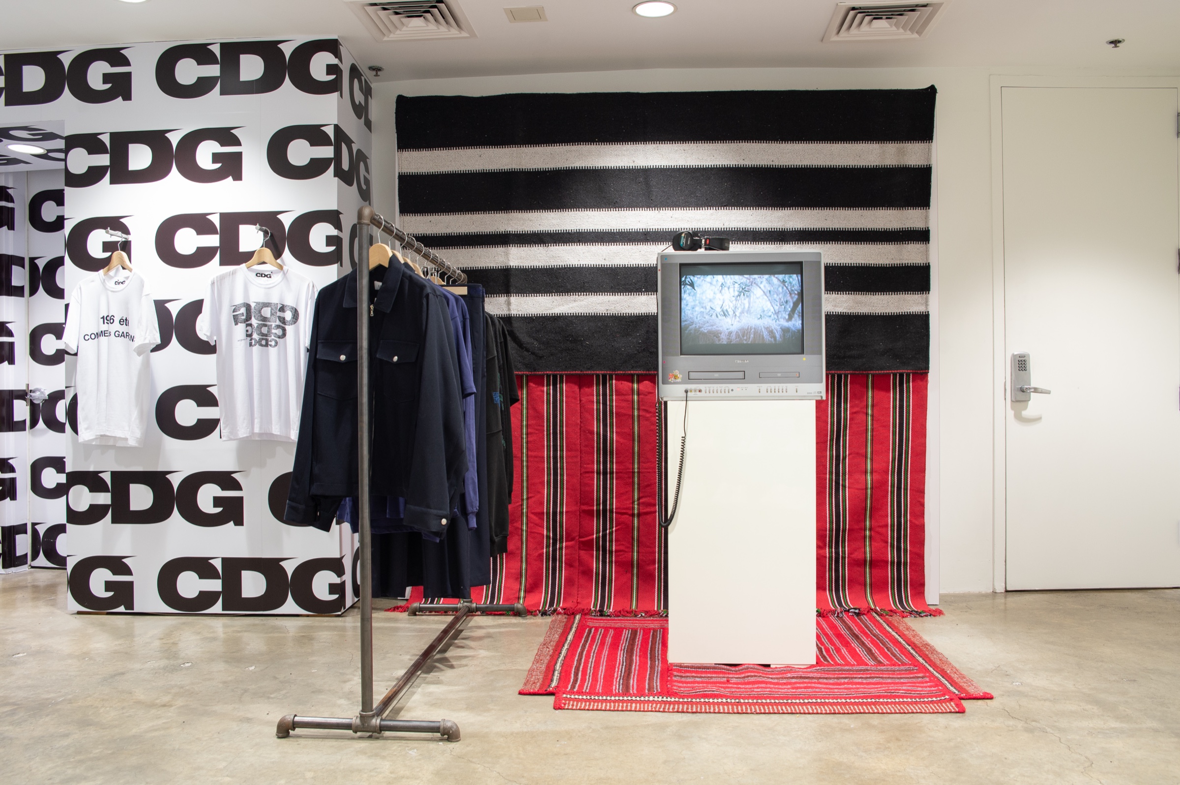 ADISH installation at Dover Street Market New York, with garments, woven textiles and a monitor showing the Lakiya film.